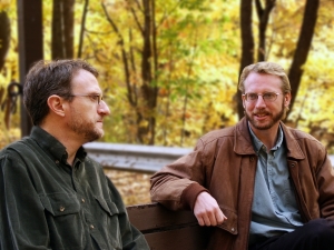 two men on lunch break at a park in autumn